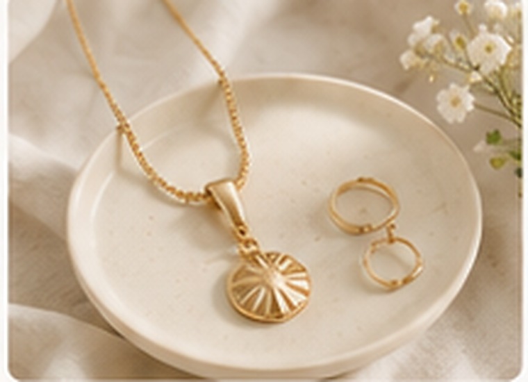 Gold accessories arranged on a ceramic dish